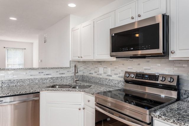 6290 Downwing Ln, Columbus, OH 43230 - kitchen featuring stainless steel appliances, backsplash, white cabinets, light stone countertops, and recessed lighting