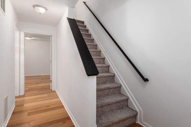 6290 Downwing Ln, Columbus, OH 43230 - stairs with wood finished floors and baseboards