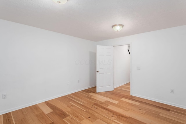 6290 Downwing Ln, Columbus, OH 43230 - unfurnished bedroom with light wood-style floors and a textured ceiling