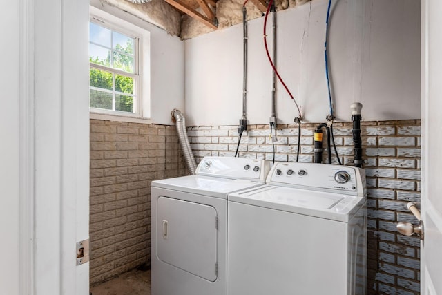 6290 Downwing Ln, Columbus, OH 43230 - laundry room with independent washer and dryer and brick wall