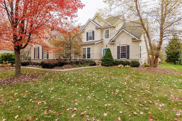 5893 Dunheath Loop, Dublin, OH 43016 - traditional-style house with stucco siding, a front lawn, and stone siding