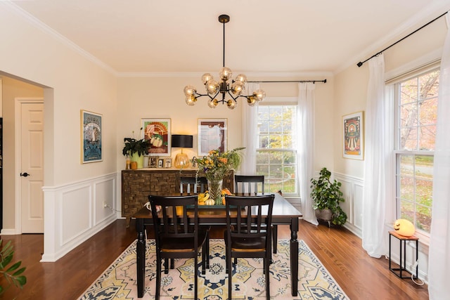 5893 Dunheath Loop, Dublin, OH 43016 - dining space with a chandelier, dark wood finished floors, ornamental molding, wainscoting, and a decorative wall