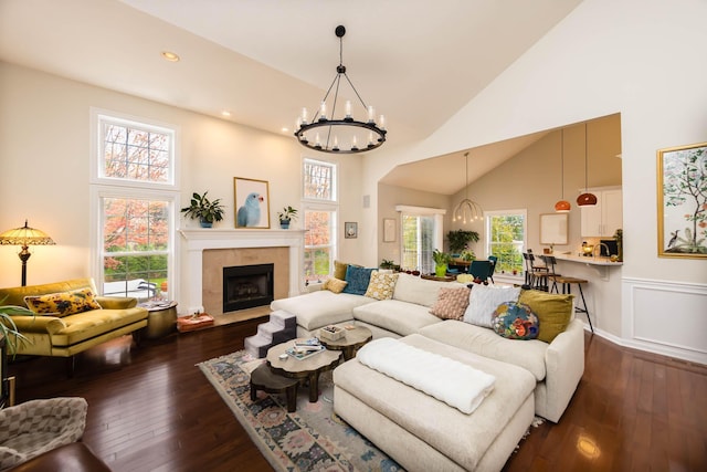 5893 Dunheath Loop, Dublin, OH 43016 - living area with a chandelier, high vaulted ceiling, dark wood-style flooring, plenty of natural light, and recessed lighting