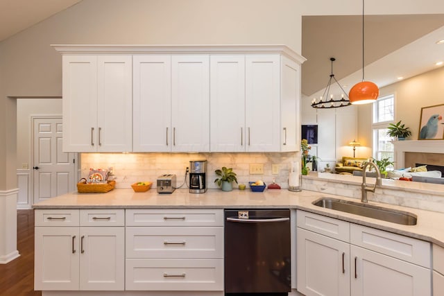 5893 Dunheath Loop, Dublin, OH 43016 - kitchen featuring dishwasher, lofted ceiling, decorative backsplash, white cabinetry, and light stone countertops