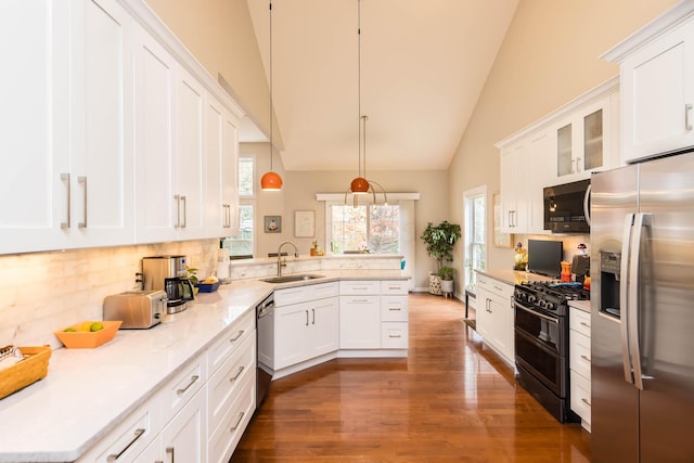 5893 Dunheath Loop, Dublin, OH 43016 - kitchen featuring stainless steel appliances, a peninsula, white cabinetry, dark wood finished floors, and backsplash