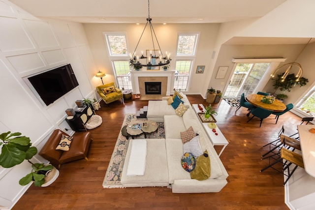 5893 Dunheath Loop, Dublin, OH 43016 - living area with a tiled fireplace, a chandelier, and wood finished floors