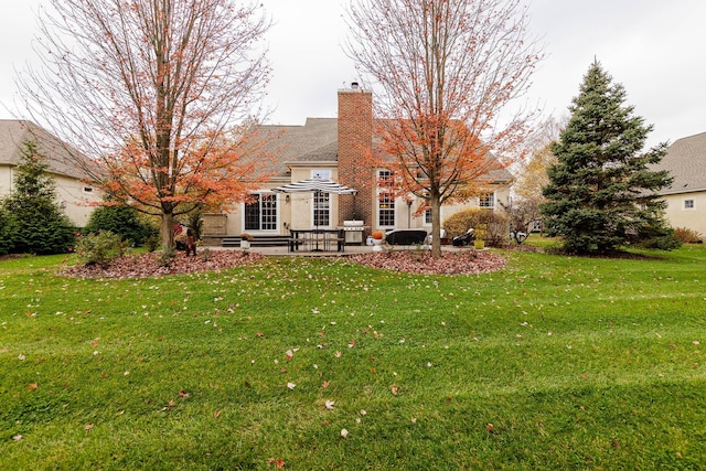5893 Dunheath Loop, Dublin, OH 43016 - back of property featuring a patio, a yard, and a chimney