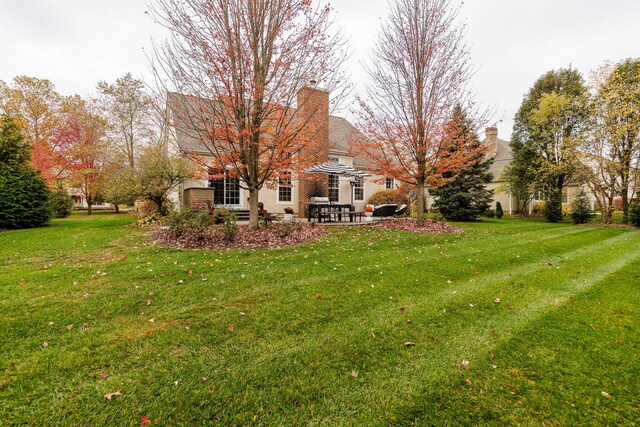 5893 Dunheath Loop, Dublin, OH 43016 - view of grassy yard featuring a patio