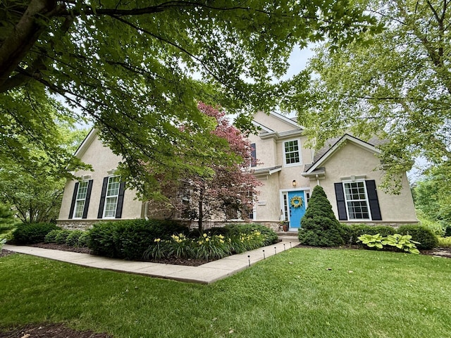 5893 Dunheath Loop, Dublin, OH 43016 - view of front of house with stucco siding, a front lawn, and stone siding