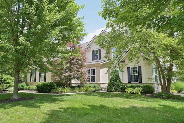 5893 Dunheath Loop, Dublin, OH 43016 - view of front facade featuring stucco siding, a front lawn, and stone siding