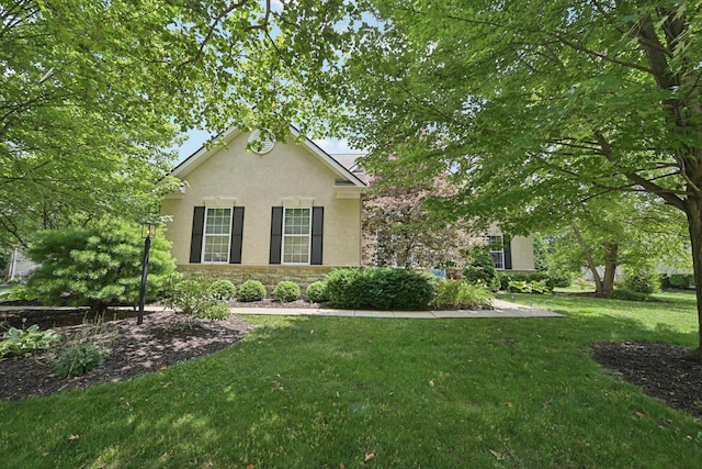 5893 Dunheath Loop, Dublin, OH 43016 - view of front of property with stone siding, stucco siding, and a front yard