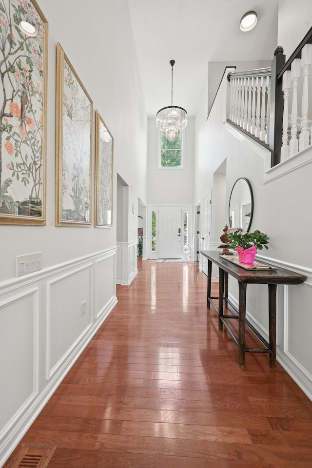 5893 Dunheath Loop, Dublin, OH 43016 - entryway featuring a high ceiling, a chandelier, and wood finished floors