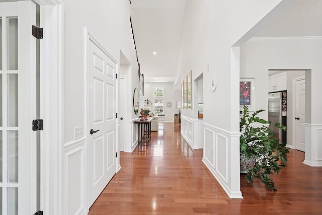 5893 Dunheath Loop, Dublin, OH 43016 - hall with light wood-style flooring, ornamental molding, and wainscoting