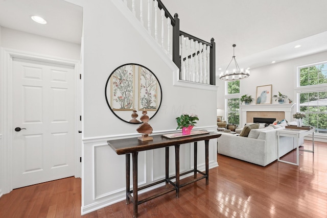 5893 Dunheath Loop, Dublin, OH 43016 - stairs with wood-type flooring, recessed lighting, a fireplace, and a chandelier