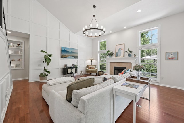 5893 Dunheath Loop, Dublin, OH 43016 - living area with healthy amount of natural light, a chandelier, a towering ceiling, dark wood-style flooring, and recessed lighting