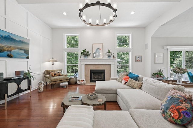 5893 Dunheath Loop, Dublin, OH 43016 - living room with healthy amount of natural light, a chandelier, dark wood-style floors, recessed lighting, and a fireplace