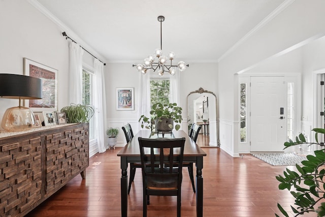 5893 Dunheath Loop, Dublin, OH 43016 - dining room with wood-type flooring, crown molding, a chandelier, wainscoting, and a decorative wall