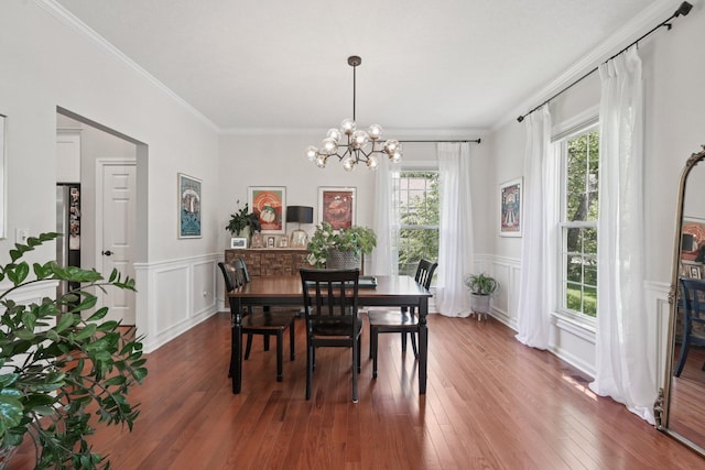 5893 Dunheath Loop, Dublin, OH 43016 - dining area with plenty of natural light, a chandelier, wood finished floors, a decorative wall, and ornamental molding