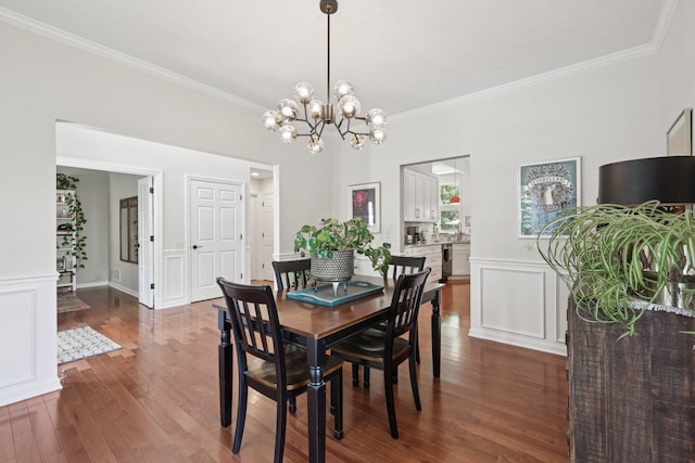 5893 Dunheath Loop, Dublin, OH 43016 - dining room with crown molding, dark wood finished floors, a chandelier, and a wainscoted wall