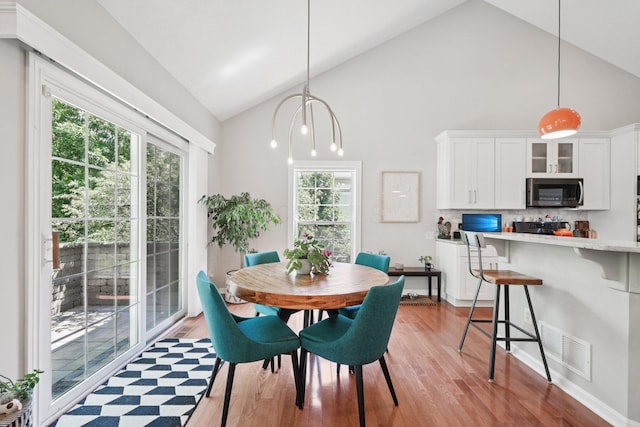 5893 Dunheath Loop, Dublin, OH 43016 - dining space featuring healthy amount of natural light, light wood-type flooring, and high vaulted ceiling