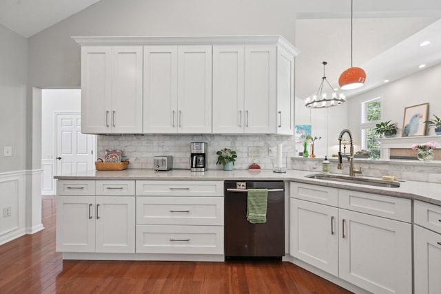 5893 Dunheath Loop, Dublin, OH 43016 - kitchen with stainless steel dishwasher, vaulted ceiling, backsplash, white cabinets, and dark wood finished floors