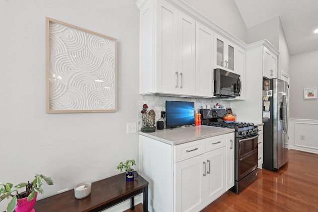 5893 Dunheath Loop, Dublin, OH 43016 - kitchen featuring appliances with stainless steel finishes, white cabinetry, dark wood-type flooring, tasteful backsplash, and wainscoting