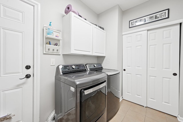 5893 Dunheath Loop, Dublin, OH 43016 - washroom with separate washer and dryer, cabinet space, and light tile patterned flooring