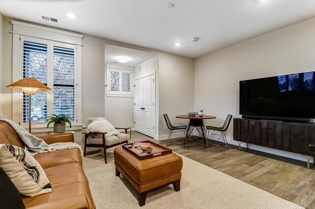 1301 Highland St, Columbus, OH 43201 - living area with wood finished floors, baseboards, and recessed lighting