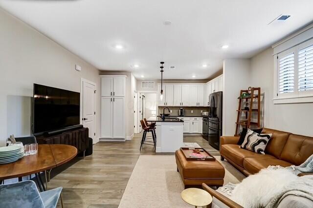 1301 Highland St, Columbus, OH 43201 - living room featuring light wood-type flooring and recessed lighting