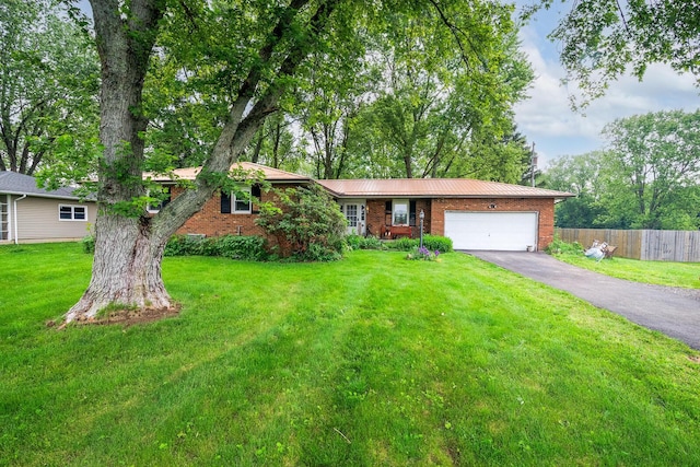 4019 Mink St SW, Pataskala, OH 43062 - ranch-style house featuring an attached garage, driveway, brick siding, and metal roof
