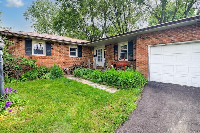 4019 Mink St SW, Pataskala, OH 43062 - ranch-style house featuring an attached garage, brick siding, a front lawn, metal roof, and asphalt driveway