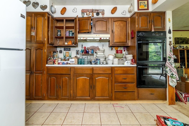 4019 Mink St SW, Pataskala, OH 43062 - kitchen featuring freestanding refrigerator, light countertops, brown cabinetry, and light tile patterned floors