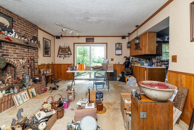 4019 Mink St SW, Pataskala, OH 43062 - dining room featuring a textured ceiling, wooden walls, a wainscoted wall, ornamental molding, and a brick fireplace