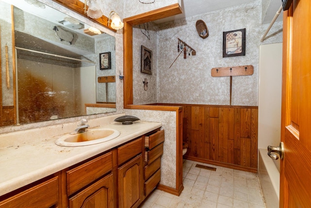 4019 Mink St SW, Pataskala, OH 43062 - full bath with vanity, toilet, a bath, a wainscoted wall, and wooden walls