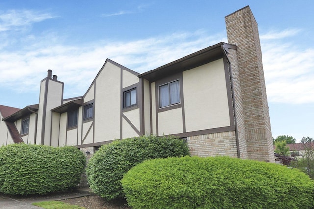 2356 Gavinley Way, Columbus, OH 43220 - view of home's exterior featuring a chimney, stucco siding, and brick siding