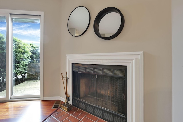 2356 Gavinley Way, Columbus, OH 43220 - detailed view of a fireplace with flush hearth, baseboards, and wood finished floors