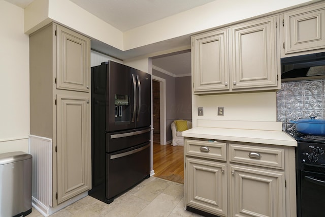 1108 Langland Dr, Columbus, OH 43220 - kitchen featuring black fridge with ice dispenser, light countertops, cream cabinets, crown molding, and range