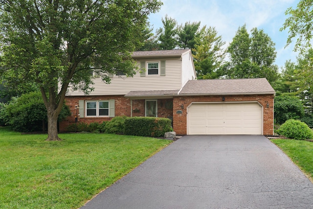 1108 Langland Dr, Columbus, OH 43220 - view of front of home featuring driveway, an attached garage, a front yard, and brick siding