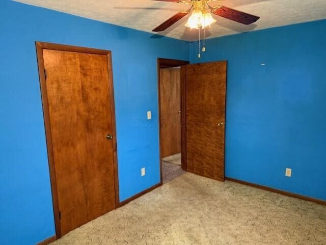 2377 E Howard Rd, Obetz, OH 43207 - unfurnished bedroom featuring carpet floors, ceiling fan, and a textured ceiling