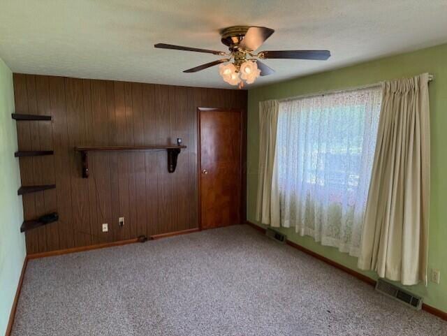 2377 E Howard Rd, Obetz, OH 43207 - carpeted spare room with a ceiling fan and wooden walls