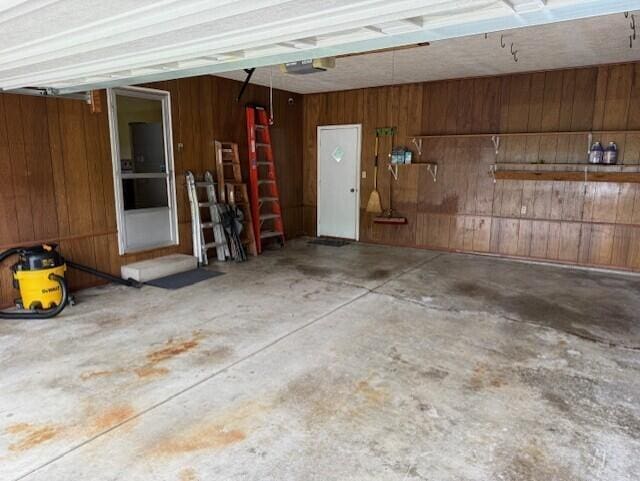 2377 E Howard Rd, Obetz, OH 43207 - garage with wood walls and a garage door opener