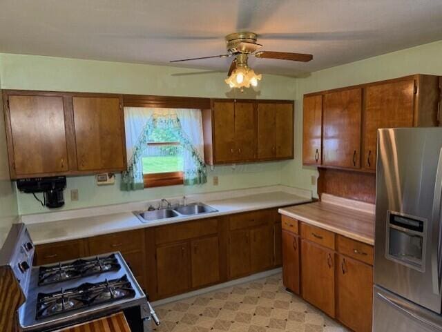 2377 E Howard Rd, Obetz, OH 43207 - kitchen with stainless steel fridge with ice dispenser, stove, brown cabinetry, and light countertops