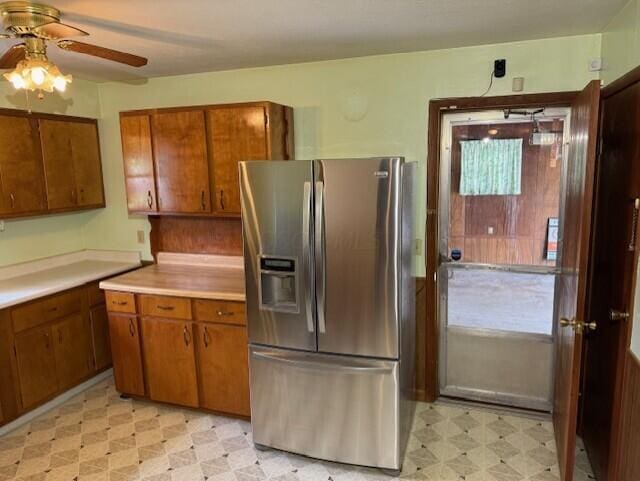 2377 E Howard Rd, Obetz, OH 43207 - kitchen with stainless steel fridge with ice dispenser, light floors, ceiling fan, and brown cabinetry