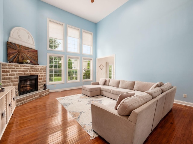 6165 Avocet Ct, Dublin, OH 43017 - living room with a towering ceiling, a glass covered fireplace, and wood-type flooring