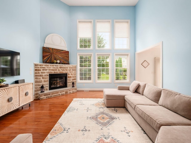 6165 Avocet Ct, Dublin, OH 43017 - living area with a high ceiling, wood finished floors, and a glass covered fireplace