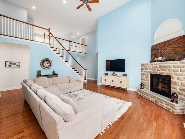 6165 Avocet Ct, Dublin, OH 43017 - living room featuring a ceiling fan, a high ceiling, a fireplace, recessed lighting, and stairway