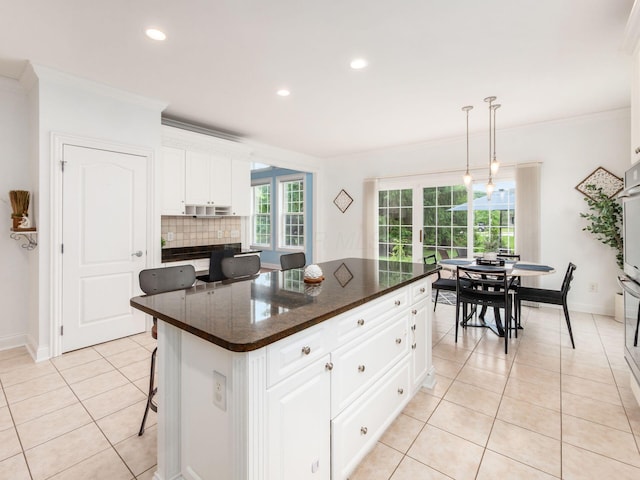 6165 Avocet Ct, Dublin, OH 43017 - kitchen with light tile patterned floors, crown molding, decorative backsplash, white cabinets, and recessed lighting