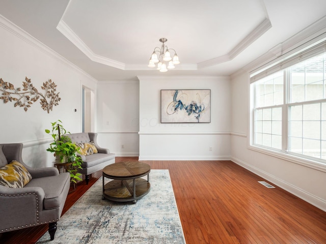6165 Avocet Ct, Dublin, OH 43017 - sitting room featuring a chandelier, crown molding, wood finished floors, and a raised ceiling