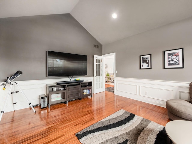 6165 Avocet Ct, Dublin, OH 43017 - living room featuring high vaulted ceiling, a wainscoted wall, wood finished floors, and a decorative wall