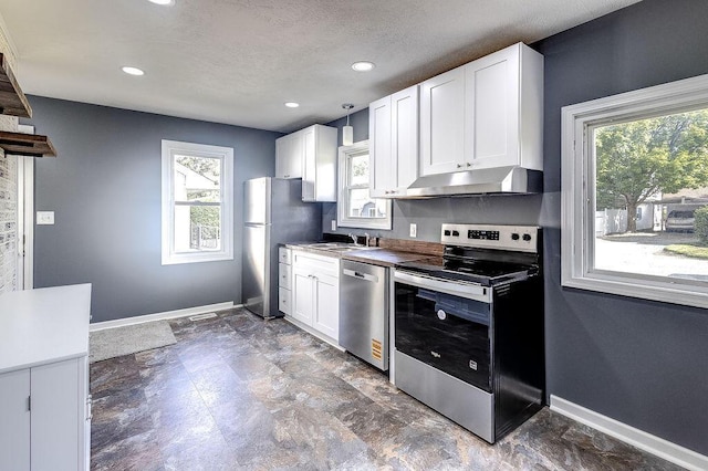 805 E Burgess St, Mount Vernon, OH 43050 - kitchen featuring stainless steel appliances, under cabinet range hood, healthy amount of natural light, white cabinetry, and recessed lighting